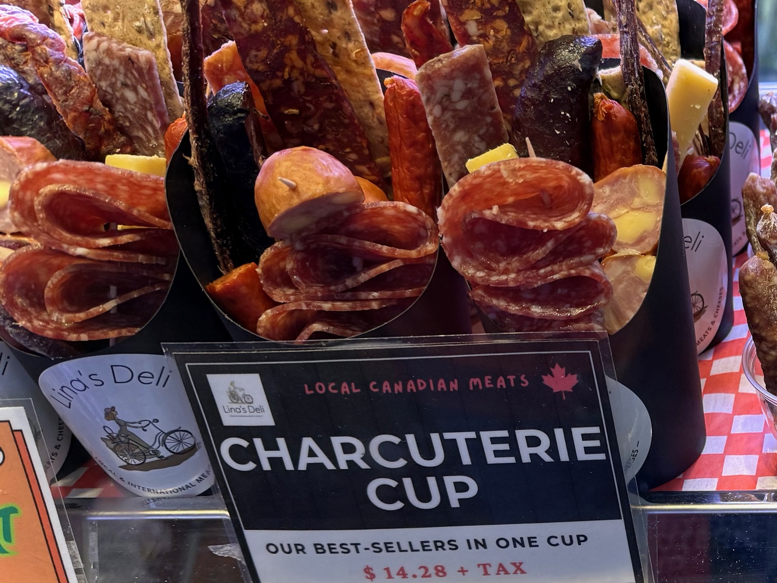 A small shot glass of charcuterie samples at Granville Island Market.