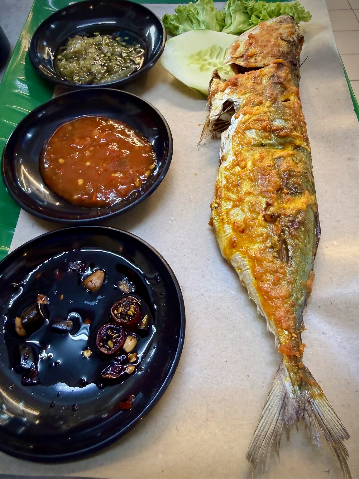 Whole grilled mackerel served with a dipping sauce