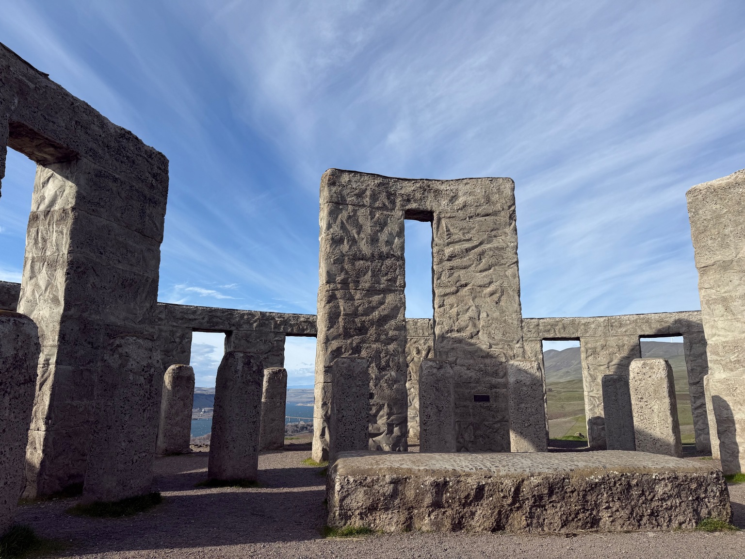 Maryhill Stonehenge monument overlooking the Columbia River Gorge under streaked blue sky.