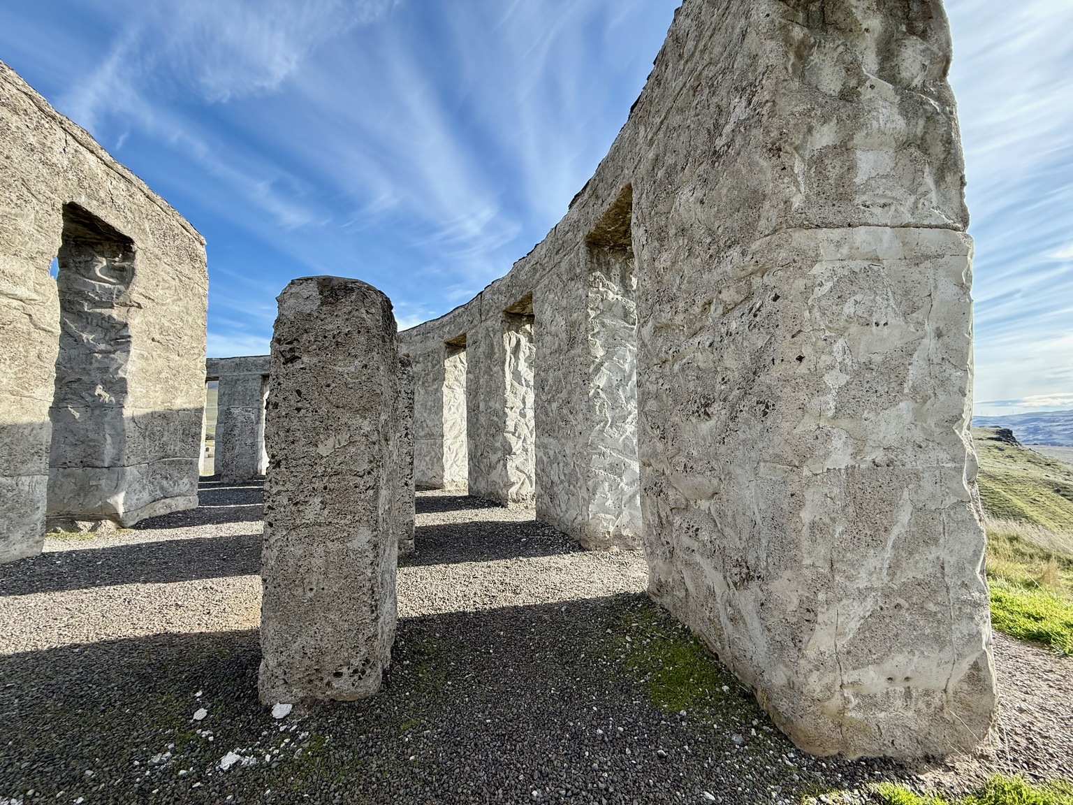 Inside Maryhill Stonehenge, stone pillars and openings framing the sky.