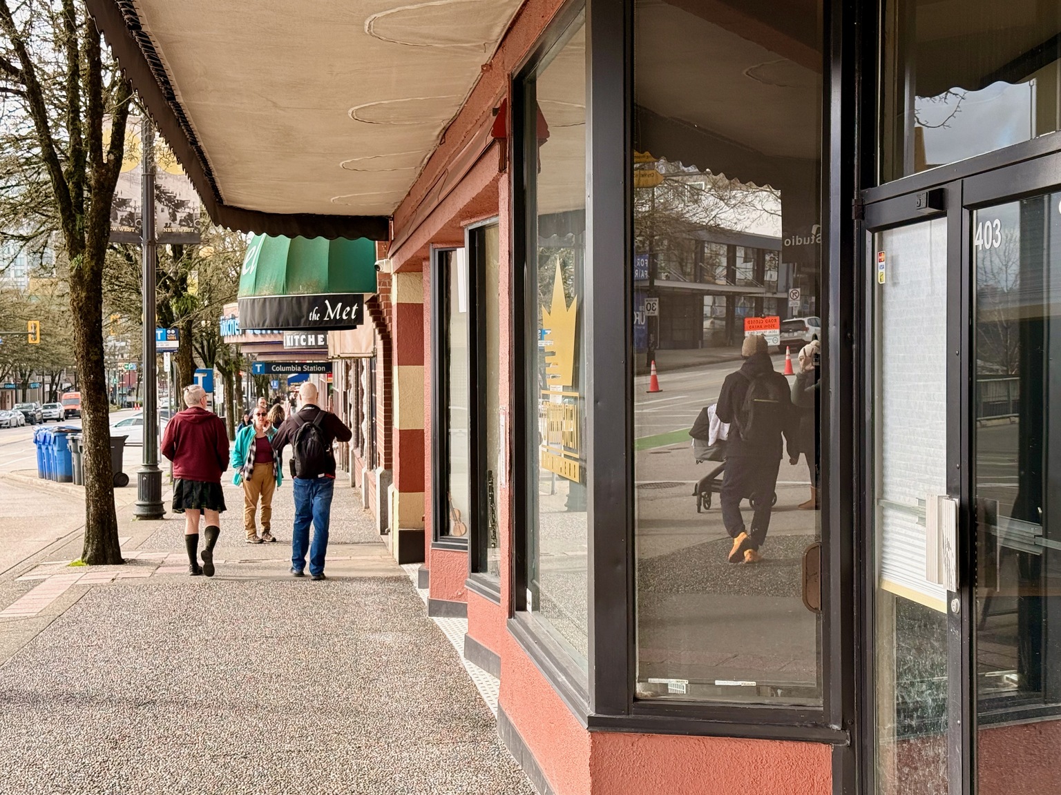 Walking through New Westminster's older streets, brick and mixed architecture lining a gentle slope.